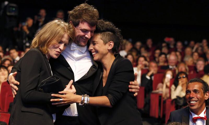 From left, Claire Burger, Samuel Theis and Marie Amachoukeli celebrate after winning the Camera d'Or award. AP