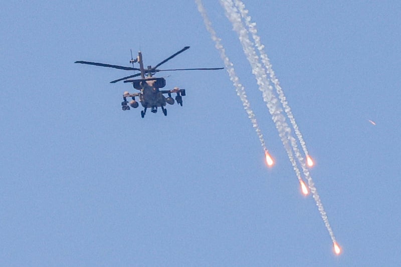 An Israeli military AH-64 Apache helicopter fires flares over the city of Ashkelon in southern Israel. AFP