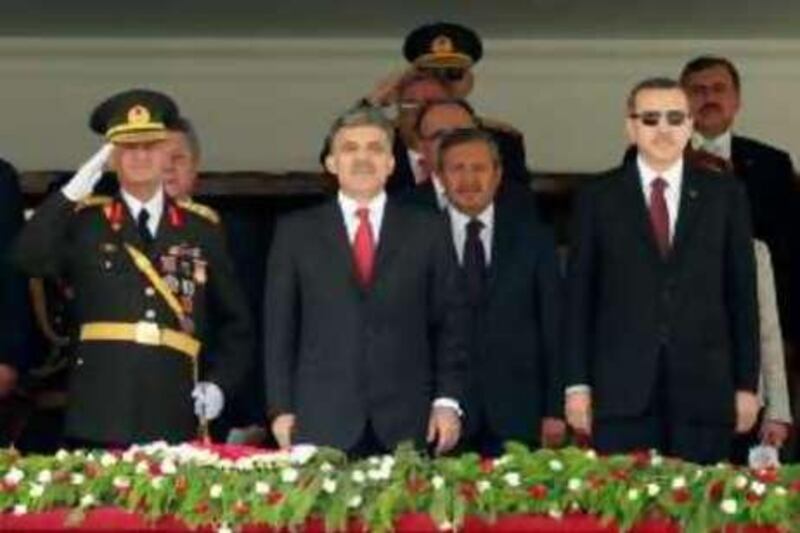 Turkey's new Chief of Staff General Ilker Basbug salutes as he stands next to President Abdullah Gul (C) and Prime Minister Tayyip Erdogan (R) during a military parade on the 86th anniversary of Victory Day in Ankara, August 30, 2008. Tensions between Turkey's government and its powerful generals will continue clouding the future of the European Union-applicant country, after the new military commander warned against the rising profile of Islam.   REUTERS/Fatih Saribas  (TURKEY)