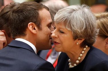 France's Emmanuel Macron greets UK leader Theresa May. Reuters