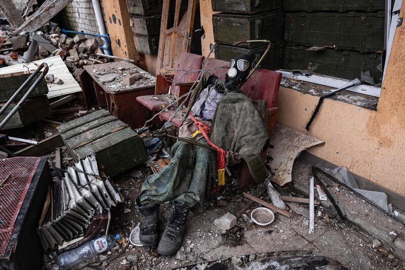 A decoy dummy made with the clothes of a Russian soldier at the entrance of a destroyed cinema in Kamyanka, eastern Ukraine.  AFP