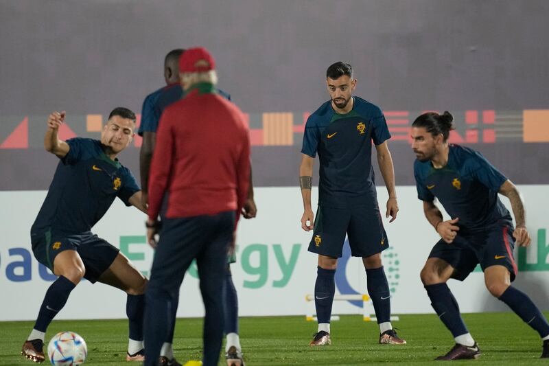Portugal's Bruno Fernandes, second from right, warms up during training. AP