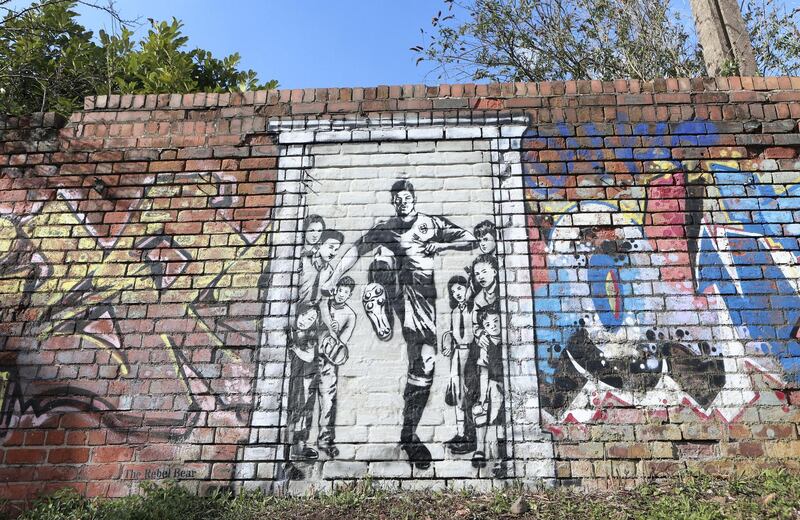 MANCHESTER, ENGLAND - MARCH 26: A mural of Manchester United player Marcus Rashford kicking down the door to No10 is seen by a canal near Old Trafford, the home of Manchester United FC, on March 26, 2021 in Manchester, England. (Photo by James Gill - Danehouse/Getty Images)