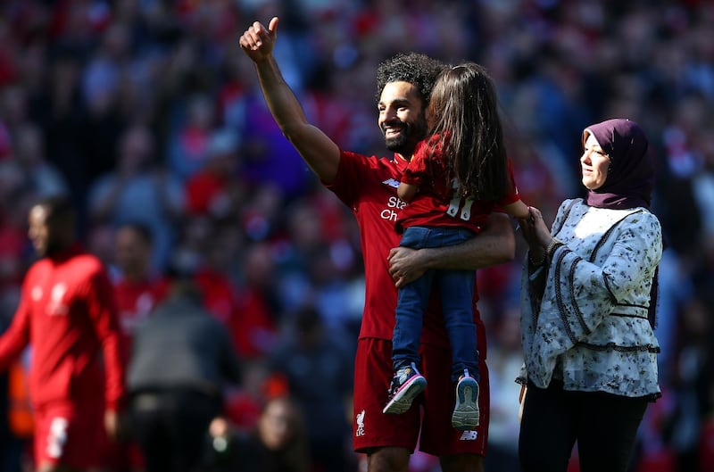 Liverpool's Mohamed Salah, accompanied by his wife Magi greets supporters while holding his daughter Makka. AP Photo