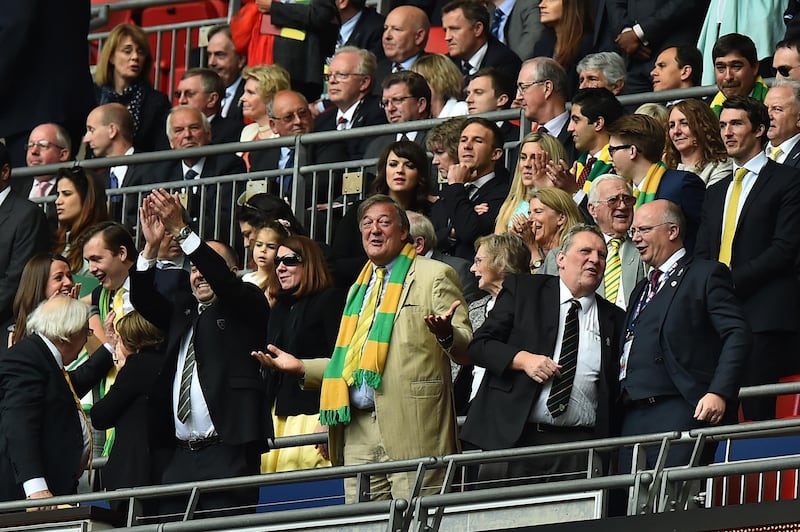 British actor Stephen Fry (C) reacts in the stands after the final whistle of the English Championship play off final football match between Middlesbrough and Norwich City at Wembley Stadium in London on May 25, 2015. Norwich City won 2-0 to earn promotion to the Premier League. AFP PHOTO / BEN STANSALL

NOT FOR MARKETING OR ADVERTISING USE / RESTRICTED TO EDITORIAL USE (Photo by BEN STANSALL / AFP)