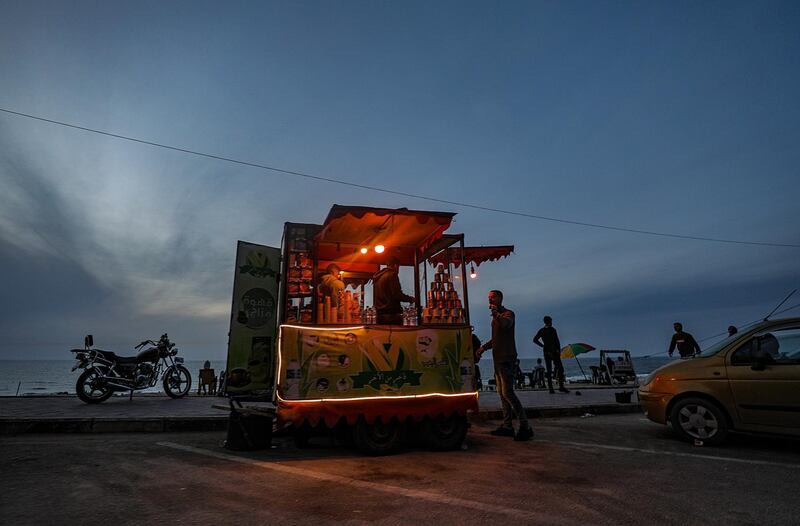 A Palestinian sells coffee and corn on the beach at sunset in Gaza City, Gaza Strip. EPA