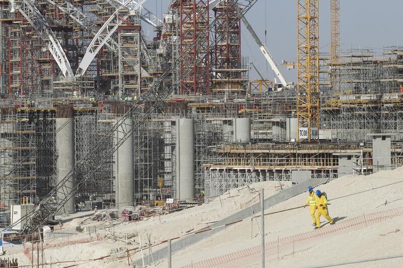 More than 18,000 workers, 42 tower cranes and 35 mobile cranes are currently working on site to keep the project on time. Mona Al Marzooqi / The National