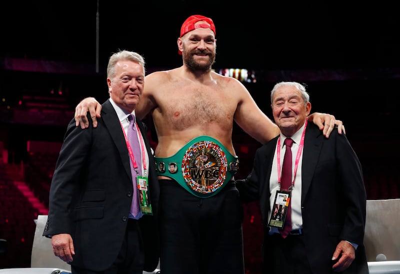 Tyson Fury poses for a photograph with promoters Frank Warren and Bob Arum. Reuters
