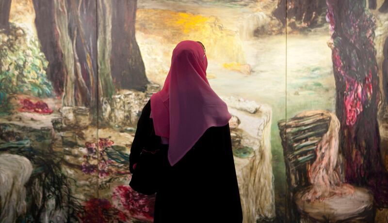 UAE - Sharjah - March 16- 2011:  A woman watch a painting by Ziad Dalloul during the Sharjah Biennial at the Sharjah Art Museum. ( Jaime Puebla - The National Newspaper )