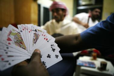 You'll always find a collective of noisy card players in Abu Dhabi's shisha cafes. Galen Clarke / The National