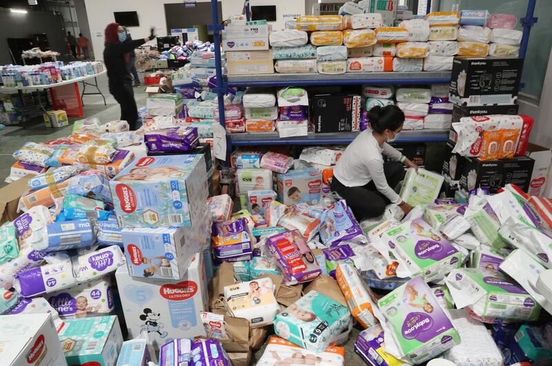 Volunteers sort donated supplies for residents of the Alfred Street public housing tower in North Melbourne, Victoria, Australia. EPA