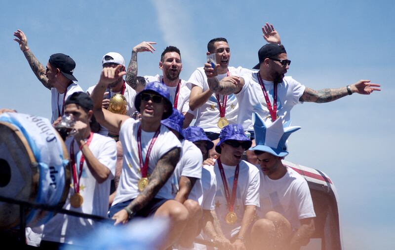 Argentina's Lionel Messi, Angel Di Maria with teammates during the victory parade. Reuters