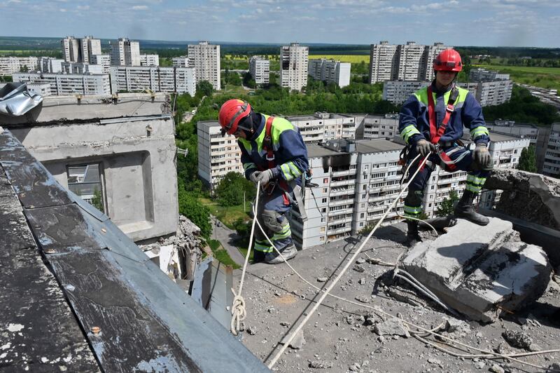 Rescuers dismantle collapsing structures of a heavily damaged 16-storey residential building in the Saltivka district of Kharkiv. AFP