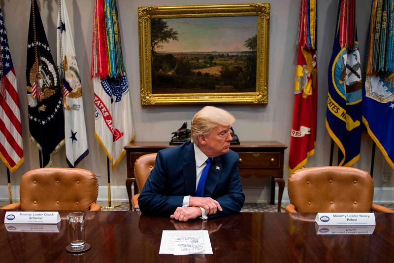 US president Donald Trump makes a statement from the Roosevelt Room next to the empty chairs of senate minority leader Chuck Schumer, and house minority leader Nancy Pelosi, after they cancelled their meeting at the White House. Jim Watson / AFP Photo
