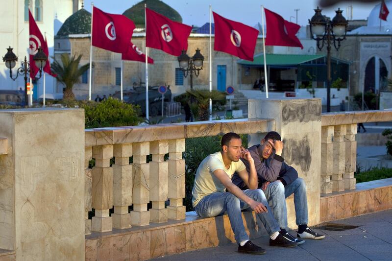 Young men hang out near the National Monument at Place de la Kasbah, as they talk and wach the passerbyes by on monday evening, April 18, 2011, in Tunis, the capital of Tunisia. The high unemployment, especially amongst the young, which in part sparked the country's January revolution, is only becoming more aparent as Tunisia enjoys its first few months of political freedom and stands at the beginning of its economic responsibility. (Silvia Razgova/The National)
