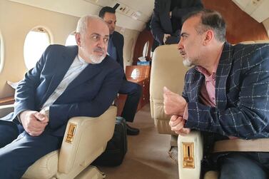 A handout photo made available by Iranian Foreign Affairs Minister Mohammad Javad Zarif's Twitter account on 7 December 2019 shows Zarif (L) and Iranian researcher Masoud Soleimani sitting inside an airplane at an undisclosed airport in Switzerland. EPA