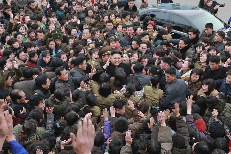 North Korean leader Kim Jong Un smiles as a huge crowd surrounds him while he gives field guidance at the Kim Jong Suk Pyongyang Textile Mill in this undated photo released by North Korea's Korean Central News Agency (KCNA) in Pyongyang on December 20, 2014. Reuters/KCNA 