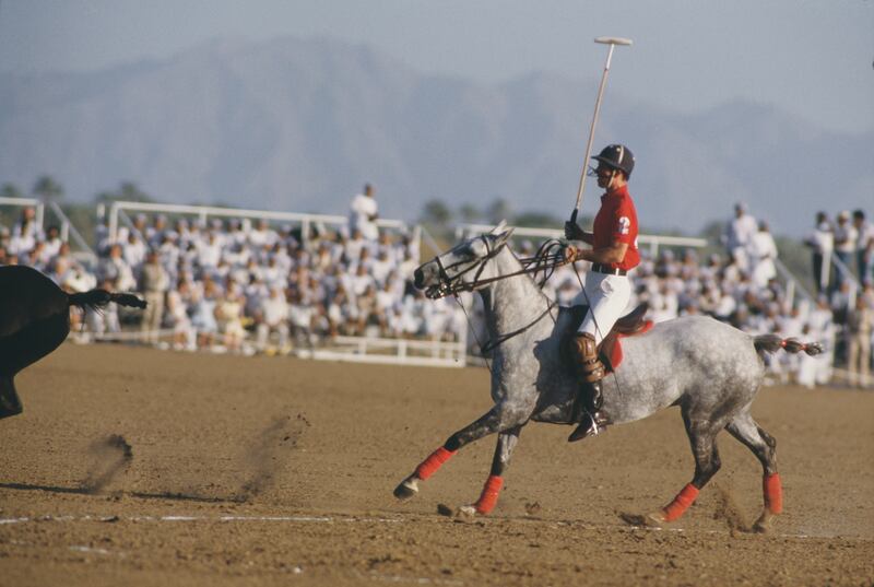 The UK's Prince Charles, now King Charles III, plays polo near Muscat, Oman, in 1986. Getty