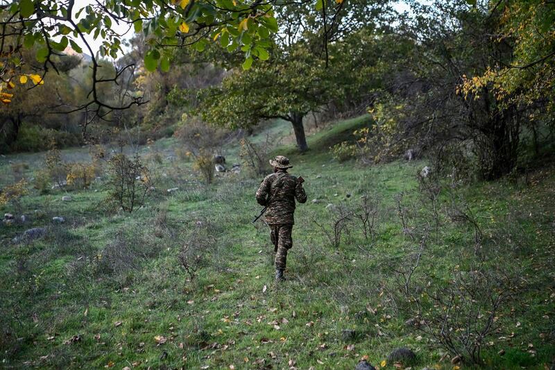 Volunteer fighters stand in a village south-east of Stepanakert during the ongoing fighting between Armenian and Azerbaijani forces. AFP