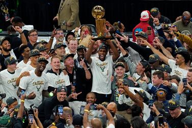 FILE - In this July 20, 2021, file photo, the Milwaukee Bucks celebrate with the championship trophy after defeating the Phoenix Suns in Game 6 of basketball's NBA Finals in Milwaukee.  (AP Photo / Paul Sancya, File)