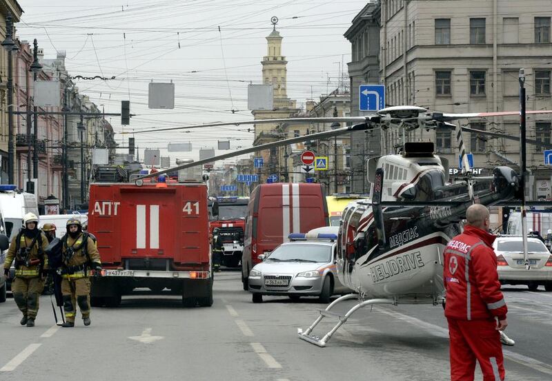 Emergency services personnel and vehicles are seen at the entrance to Technological Institute metro station in St Petersburg. Olga Maltseva / AFP