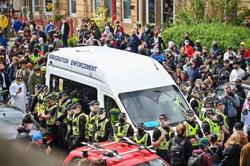 GLASGOW, SCOTLAND - MAY 13: Protestors block a immigration enforcement van, stopping it from leaving Kenmure Street in First Minister, Nicola Sturgeon's constituency on May 13, 2021 in Glsgow, Scotland. Police officers were called to Kenmure Street in Pollokshields, on the south side of the city, to support the UK Border Agency operation. (Photo by Jeff J Mitchell/Getty Images)