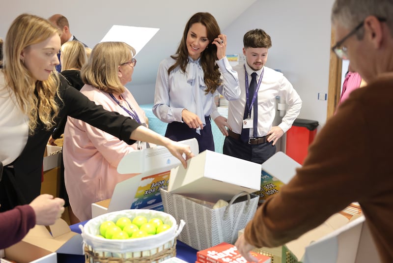 The Princess joins a group of volunteer counsellors packing the charity's 'Little Boxes of Hope', which are given to children to assist their ongoing recovery. EPA