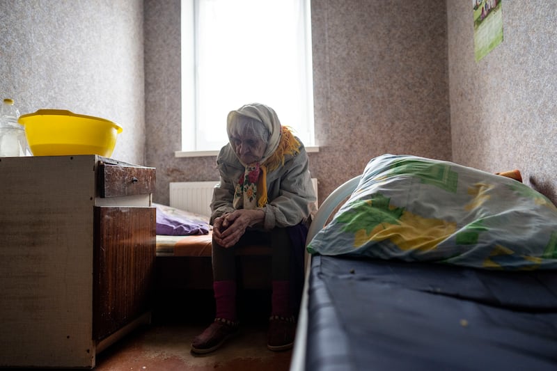 An elderly woman waits do be evacuated from a hospice in Chasiv Yar city, in Donetsk, eastern Ukraine. At least 35 residents have been helped to flee from the region that has been under attack for weeks. AP