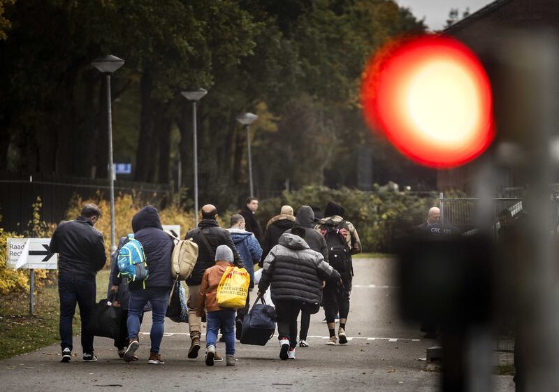 Newly arrived asylum seekers on their way to the application centre in the Groningen village of Ter Apel, the Netherlands, in October 2021. EPA