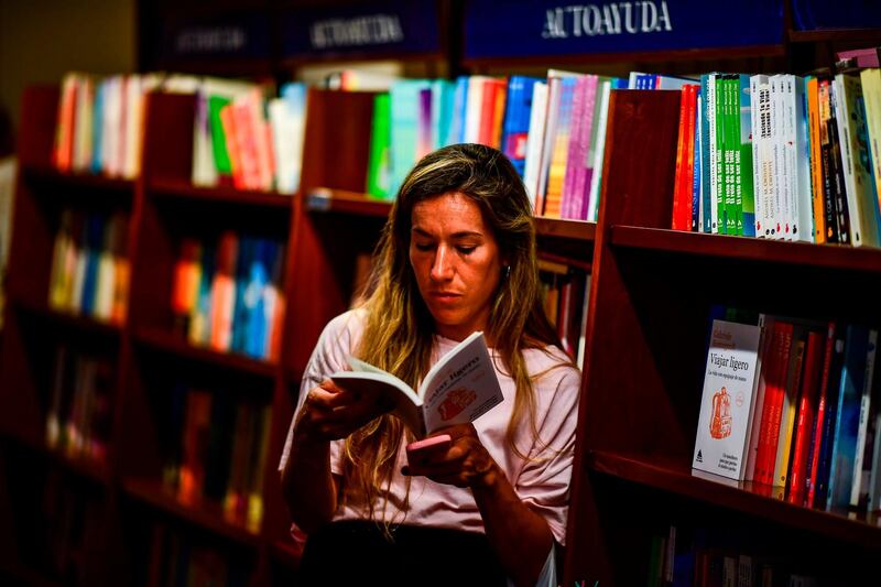 A woman looks at a book in the "El Ateneo Grand Splendid" bookstore. AFP