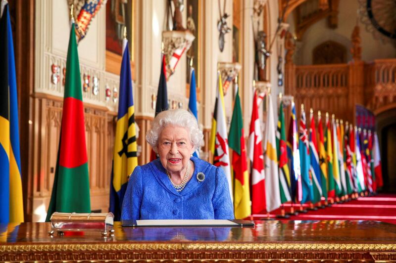 WINDSOR, UNITED KINGDOM:  In this undated image released on March 7, 2021, Queen Elizabeth II signs her annual Commonwealth Day Message in St George's Hall at Windsor Castle, to mark Commonwealth Day, in Windsor, England.  (Photo by Steve Parsons - WPA Pool/Getty Images)