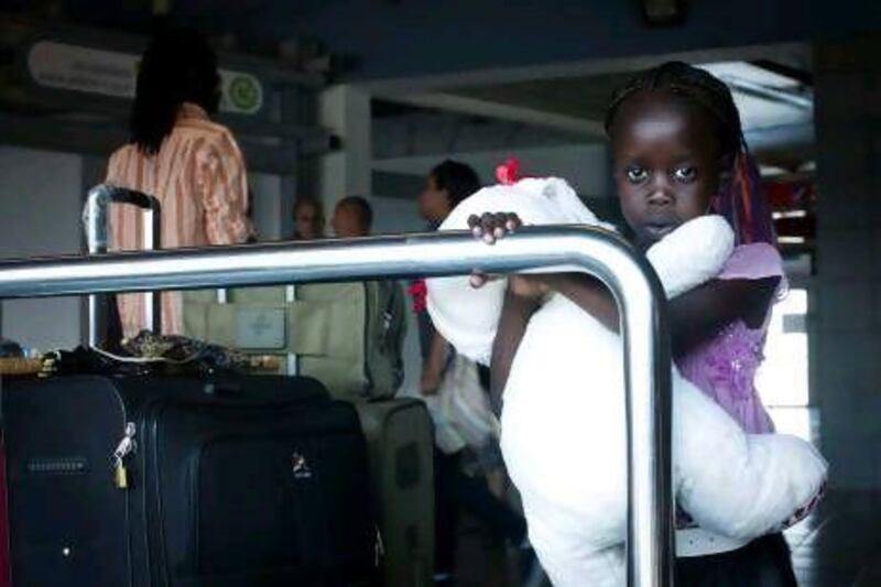 A South Sudanese girl waits with other refugees to board a bus to Ben Gurion International airport, near Tel Aviv, where they were deported to South Sudan yesterday.