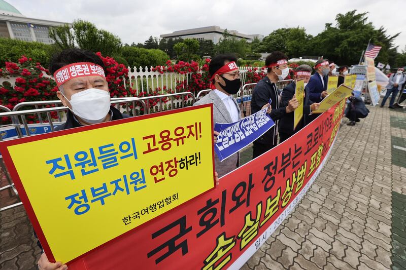 Travel industry workers protest in front of the National Assembly in Seoul, South Korea, calling for a law to enable compensation for losses faced by the industry due to coronavirus. EPA