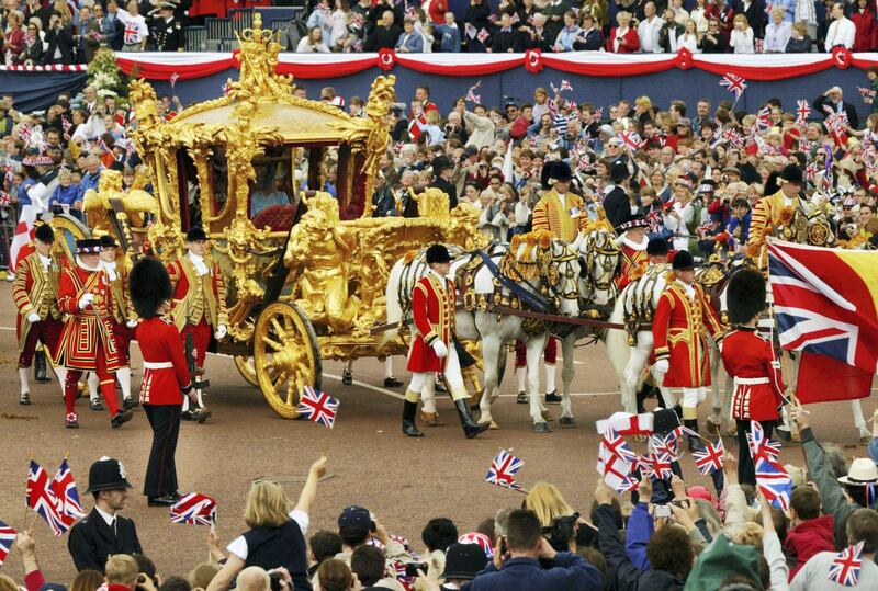 406180 04:  Britain's Queen Elizabeth (R) and Prince Philip ride in the Golden State Carriage at the head of a parade from Buckingham Palace to St Paul's Cathedral celebrating the Queen's Golden Jubilee June 4, 2002 along The Mall in London.  (Photo by Sion Touhig/Getty Images)