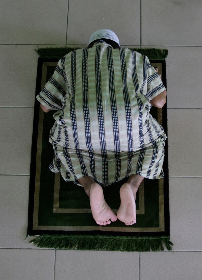 A Filipino Muslim man prays inside a mosque during the first day of the holy fasting month of Ramadan in suburban Paranaque, south of Manila, Philippines on Monday, Aug. 1, 2011. During Ramadan, the holiest month in Islamic calendar, Muslims refrain from eating, drinking, smoking and sex from dawn to dusk.  (AP Photo/Aaron Favila) *** Local Caption ***  Philippines Ramadan.JPEG-07c07.jpg