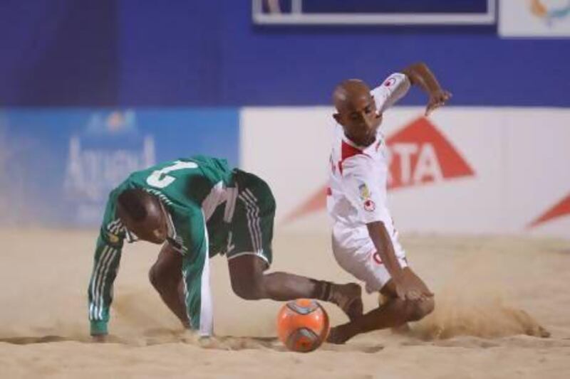 A UAE player, in white, battles for ball control with a Nigeria player back in a tournament at Dubai in November. The UAE recently returned from a tournament in Belarus finishing third. Mike Young for The National