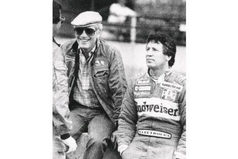The American former Formula One champion Mario Andretti seen here in 1983 with Newman on the pit wall, was the team's first driver and first race winner. John C. Hillery / Reuters / AP / Mac