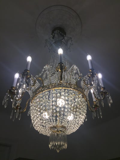 An ornate chandelier is a centrepiece in the living room