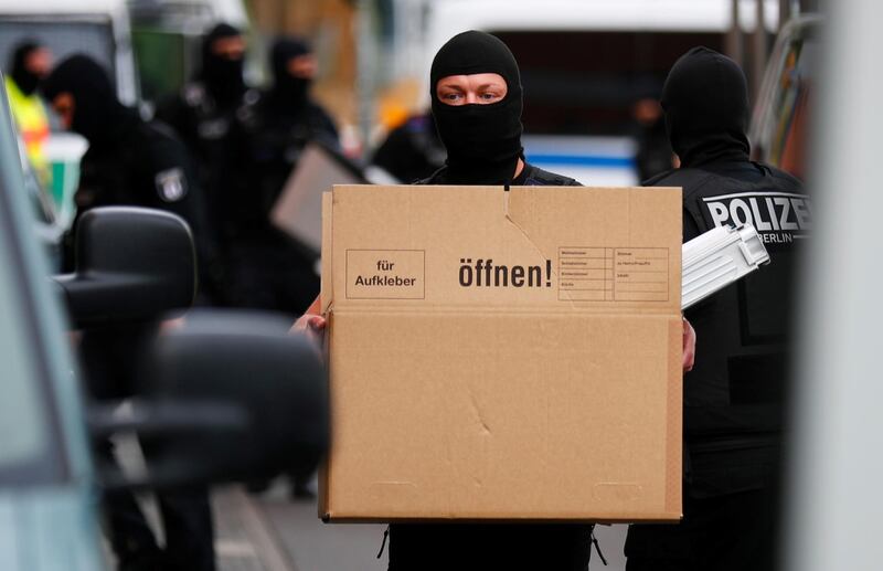 German special police carry a box from the premises of the El-Irschad (Al-Iraschad e.V.) centre in Berlin. Reuters
