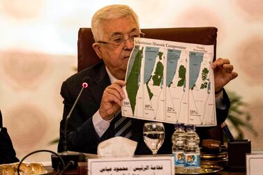 Palestinian president Mahmoud Abbas holds a placard as he attends an Arab League emergency meeting in Cairo on February 1. AFP