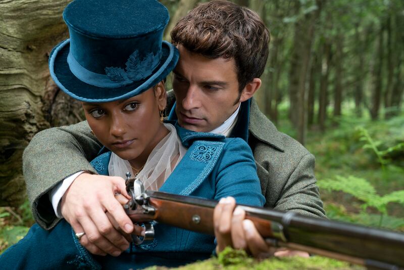 Kate Sharma (Simone Ashley) wearing a jewel-toned hunting suit with Anthony Bridgerton (Jonathan Bailey). Photo: Netflix