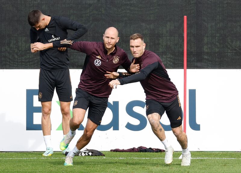 Germany special coach Benedikt Howedes and player David Raum during training. AFP