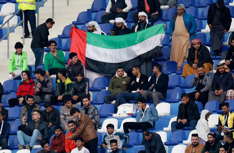 UAE fans hold up their flag in the stands. Reuters