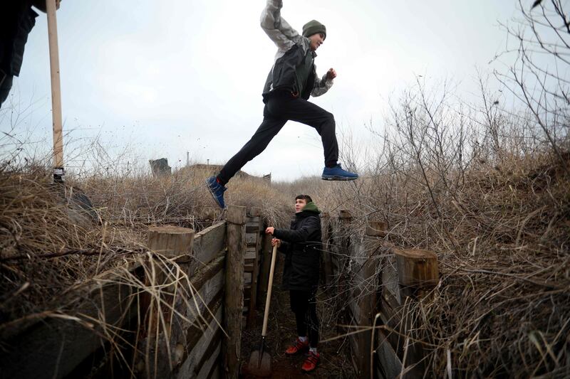 Ukrainian teenagers dig trenches for soldiers serving on their country's eastern front and facing off with Russian-backed separatists, near Chervone, in Mariupol. AFP