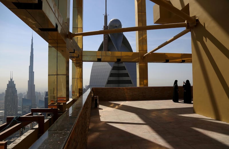 A visitor takes photos at the 71st floor of the Gevora Hotel, the world's tallest hotel, in Dubai, UAE February 12, 2018. REUTERS/Satish Kumar     TPX IMAGES OF THE DAY