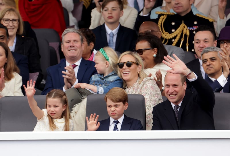 Zara Tindall, wearing a floral Zimmermann dress, at the platinum jubilee pageant held outside Buckingham Palace, in London, Sunday June 5, 2022. She is sat with daughter Lena Tindall on her lap, behind Prince William, with Prince George and Princess Charlotte. AP Photo