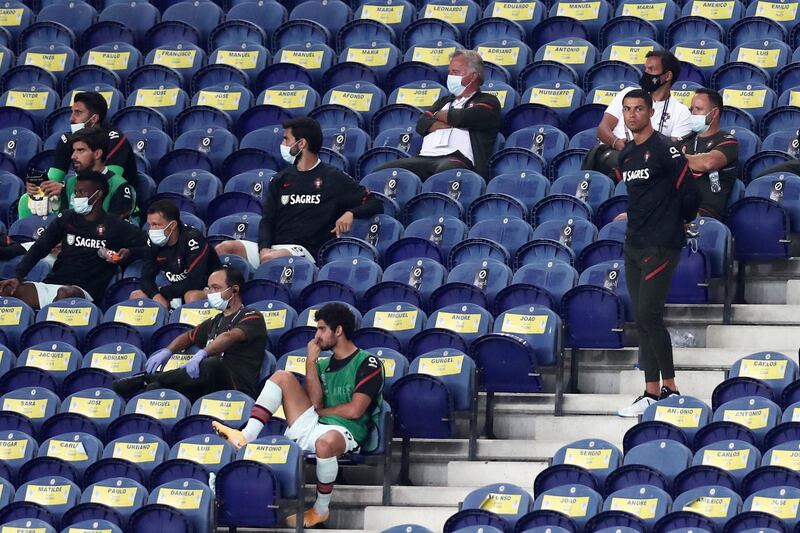 Portugal's Cristiano Ronaldo stands next to the team substitutes on the stands during the UEFA Nations League match between Portugal and Croatia. AP Photo