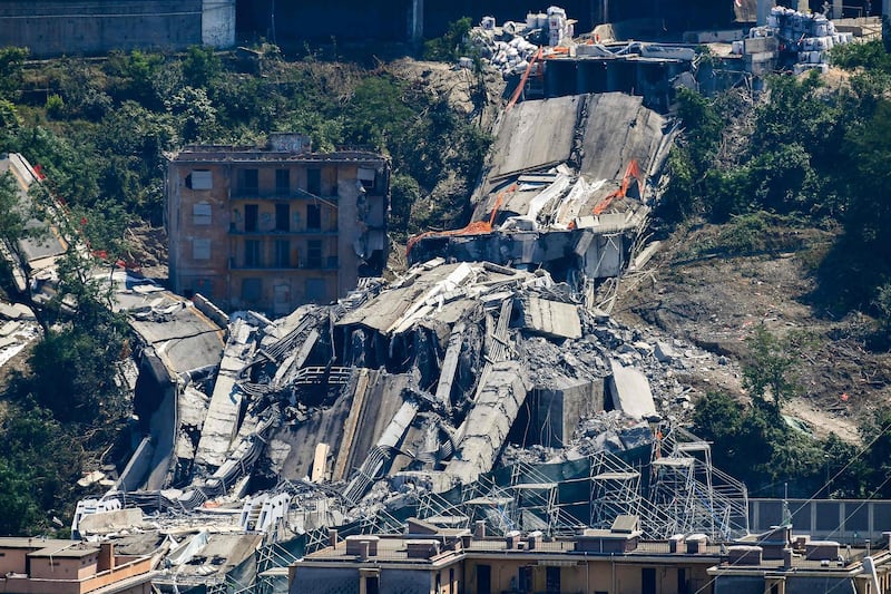 The bridge's deck debris and rubble among evacuated buildings after explosive charges blew up the eastern pylons of Genoa's Morandi motorway bridge in Genoa. AFP