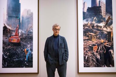 German filmmaker Wim Wenders stands next to some of the photos he took in the aftermath of the World Trade Centre's collapse. AFP 