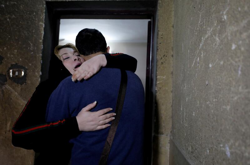 Palestinian journalist Amjad Yaghi hugs his mother, Nevine Zouheir, after 20 years of separation, in Banha, Egypt. Reuters